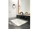 Close-up of modern bathroom sink with marble countertop and black fixtures at 3845 Delinger Dr, Mount Pleasant, SC 29466