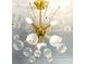 A modern sputnik chandelier with gold finish and glass globes graces this home at 3845 Delinger Dr, Mount Pleasant, SC 29466