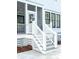 Charming white exterior with stairs leading up to the entrance, showcasing curb appeal at 3845 Delinger Dr, Mount Pleasant, SC 29466