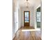 Bright foyer featuring hardwood floors, white trim, and a modern light fixture at 3845 Delinger Dr, Mount Pleasant, SC 29466