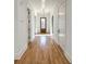 Hallway featuring hardwood floors, white trim, and a modern light fixture at 3845 Delinger Dr, Mount Pleasant, SC 29466