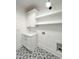 Well-organized laundry room with custom cabinets, open shelving, and stylish patterned tile flooring at 3845 Delinger Dr, Mount Pleasant, SC 29466