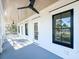 Covered porch with ceiling fan and black trimmed windows overlooks the surrounding neighborhood at 3845 Delinger Dr, Mount Pleasant, SC 29466