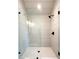 Modern shower featuring glass doors, black hardware, and vertical white subway tile surround at 3845 Delinger Dr, Mount Pleasant, SC 29466