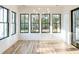 Sun-drenched sun room with hardwood floors, black-framed windows, and a modern chandelier at 3845 Delinger Dr, Mount Pleasant, SC 29466