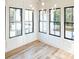 Bright sun room featuring hardwood floors, white trim, and black-framed windows at 3845 Delinger Dr, Mount Pleasant, SC 29466
