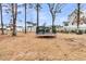 Spacious backyard featuring a trampoline, lush landscaping, and a serene view at 3851 Sawyers Island Dr, Mount Pleasant, SC 29466