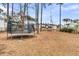 Large trampoline in a spacious backyard, surrounded by lush landscaping and tall trees at 3851 Sawyers Island Dr, Mount Pleasant, SC 29466
