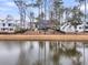 Beautiful waterfront view of a pond with lush landscaping and a black metal fence at 3851 Sawyers Island Dr, Mount Pleasant, SC 29466
