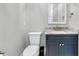 Elegant bathroom features a marble countertop, and navy blue cabinets at 3851 Sawyers Island Dr, Mount Pleasant, SC 29466
