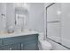 Bathroom featuring white tiling in the shower, a blue vanity, and quartz countertops at 3851 Sawyers Island Dr, Mount Pleasant, SC 29466