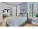 Comfortable bedroom with pale blue walls, white trim and shutters, and wood flooring at 3851 Sawyers Island Dr, Mount Pleasant, SC 29466