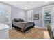 Bedroom featuring hardwood floors, shutters, neutral color scheme and glass doors to a balcony at 3851 Sawyers Island Dr, Mount Pleasant, SC 29466