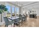 Elegant dining area featuring a stylish chandelier, large windows, and seamless flow into the modern kitchen at 3851 Sawyers Island Dr, Mount Pleasant, SC 29466