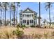Charming two-story home with a double porch and manicured front yard at 3851 Sawyers Island Dr, Mount Pleasant, SC 29466