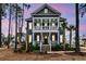 Inviting two-story home with double porches, lush greenery, and elegant brick stairs and walkway at 3851 Sawyers Island Dr, Mount Pleasant, SC 29466