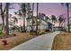 Beautiful two-story home with a double porch along a curved driveway and landscaped front yard at 3851 Sawyers Island Dr, Mount Pleasant, SC 29466