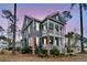 Charming two-story home with a double porch, beautiful landscaping, and curb appeal at dusk at 3851 Sawyers Island Dr, Mount Pleasant, SC 29466