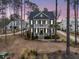 Stately two-story home with a double porch and manicured landscaping in a wooded setting at 3851 Sawyers Island Dr, Mount Pleasant, SC 29466