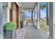 Charming front porch with stylish decor, including a cozy bench, potted plants, and an inviting entrance at 3851 Sawyers Island Dr, Mount Pleasant, SC 29466