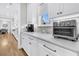 Modern kitchen with white cabinets, marble countertops, and stainless steel appliances at 3851 Sawyers Island Dr, Mount Pleasant, SC 29466