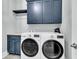 Convenient laundry room with front-load washer/dryer, custom cabinets, and decorative tile flooring at 3851 Sawyers Island Dr, Mount Pleasant, SC 29466