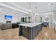 Open concept living and kitchen area featuring hardwood floors and coffered ceilings at 3851 Sawyers Island Dr, Mount Pleasant, SC 29466