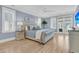 Main bedroom with hardwood floors, plantation shutters, side tables, and access to balcony at 3851 Sawyers Island Dr, Mount Pleasant, SC 29466