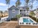 A stunning backyard oasis features a private pool, jacuzzi, lounge area, and pristine landscaping at 3851 Sawyers Island Dr, Mount Pleasant, SC 29466