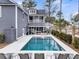 An aerial view of the pool with lounge chairs, a covered lounge, and a fenced yard at 3851 Sawyers Island Dr, Mount Pleasant, SC 29466