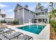 Private backyard oasis featuring a sparkling pool, hot tub, lounge chairs, and outdoor seating area for relaxation at 3851 Sawyers Island Dr, Mount Pleasant, SC 29466