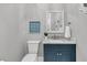 This powder room features a blue vanity and decorative mirror at 3851 Sawyers Island Dr, Mount Pleasant, SC 29466