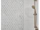 This shower features white tile with a decorative accent, as well as bronze fixtures at 3851 Sawyers Island Dr, Mount Pleasant, SC 29466