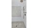 This shower features white tile with a decorative accent, as well as bronze fixtures at 3851 Sawyers Island Dr, Mount Pleasant, SC 29466