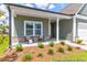 Charming front porch of a single-Gathering home with brick accents and a cozy seating area at 411 Avocet Dr # 554P, Summerville, SC 29486