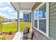 Covered front porch with comfortable seating and a view of the landscaped yard at 411 Avocet Dr # 554P, Summerville, SC 29486