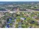 An aerial view shows neighborhood homes bordering a commercial road with wooded backdrop on a sunny day at 512 Resinwood Rd, Moncks Corner, SC 29461