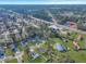 Aerial view captures a mix of residential and commercial properties adjacent to a lush wooded area at 512 Resinwood Rd, Moncks Corner, SC 29461