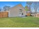A grassy backyard with a wooden privacy fence and a small rear patio area at 512 Resinwood Rd, Moncks Corner, SC 29461