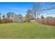 Lush, green backyard surrounded by a tall wooden privacy fence at 512 Resinwood Rd, Moncks Corner, SC 29461