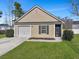 Well-kept home with a garage and a manicured front lawn at 512 Resinwood Rd, Moncks Corner, SC 29461