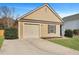 A cute single-story house boasts a well-kept lawn and an attached single-car garage at 512 Resinwood Rd, Moncks Corner, SC 29461