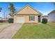 Charming single-story home with yellow siding, a garage, and a well-maintained lawn at 512 Resinwood Rd, Moncks Corner, SC 29461