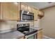 A well-equipped kitchen with stainless steel appliances and light wood cabinets at 512 Resinwood Rd, Moncks Corner, SC 29461
