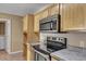 Well-organized kitchen features stainless steel microwave, cabinets, and oven range at 512 Resinwood Rd, Moncks Corner, SC 29461