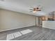 An open-concept living room with wood floors, and seamlessly connected to the kitchen at 512 Resinwood Rd, Moncks Corner, SC 29461