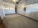 View of the spacious garage with rough drywall, overhead door and water heater at 5120 Double Eagle, Summerville, SC 29485