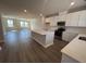 Open-concept kitchen features quartz countertops, stainless appliances, and an island at 5120 Double Eagle, Summerville, SC 29485