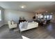 An open-concept living area featuring a modern sofa, a dining table, and an island kitchen at 5120 Double Eagle, Summerville, SC 29485