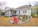 Backyard patio with an outdoor kitchen, furniture, fireplace, grill, and plenty of entertaining space at 5358 Birdie Ln, Hollywood, SC 29449